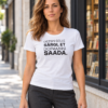 Carolina outside a bookshop wearing a white women’s T-shirt with the Estonian print “Ostsin selle särgi, et dopamiini saada.”