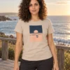 Lucía kannab liivakarva South Swelli unisex T-särki mereäärsel puidust terrassil.
